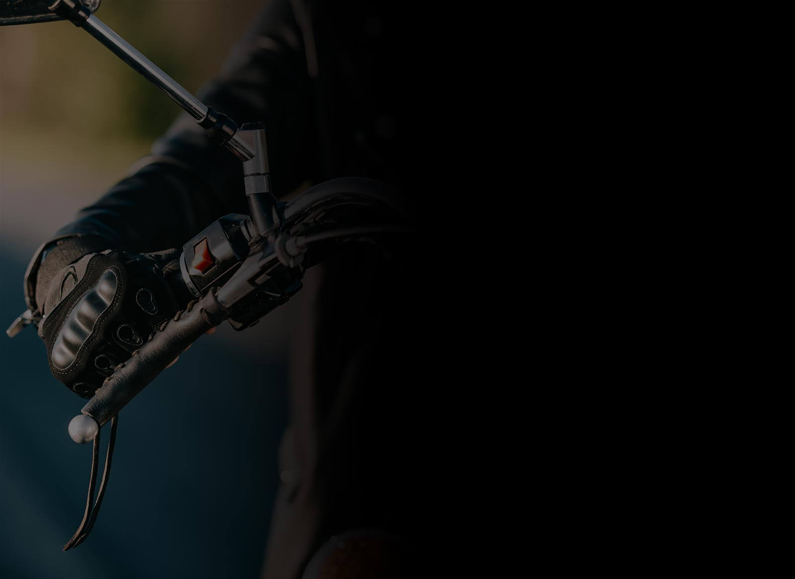 cropped view of biker with bike gloves on classic motorcycle