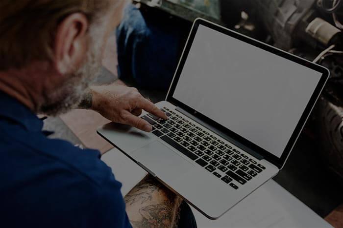 garage motorcycle tuning adjustment with laptop