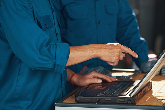 mechanics discussing motorcycle tuning process