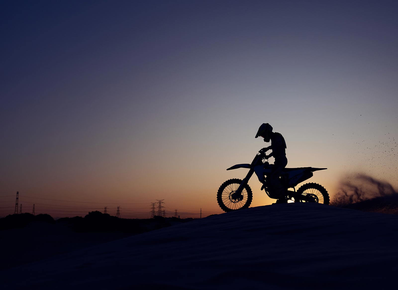 night sky silhouette of person on motorcycle