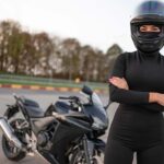 female-motorcyclist-in-helmet-and-black-clothes